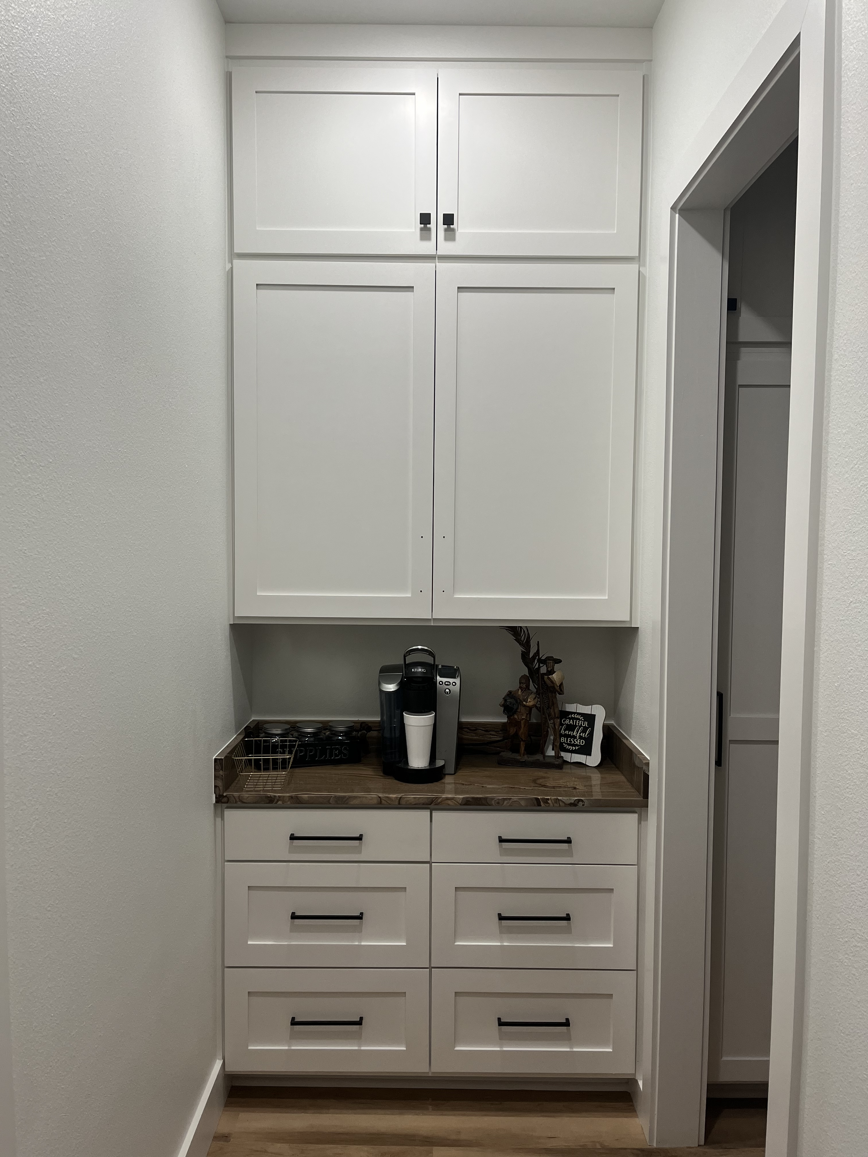 Butler's pantry coffee nook with white shaker cabinets and walnut counter