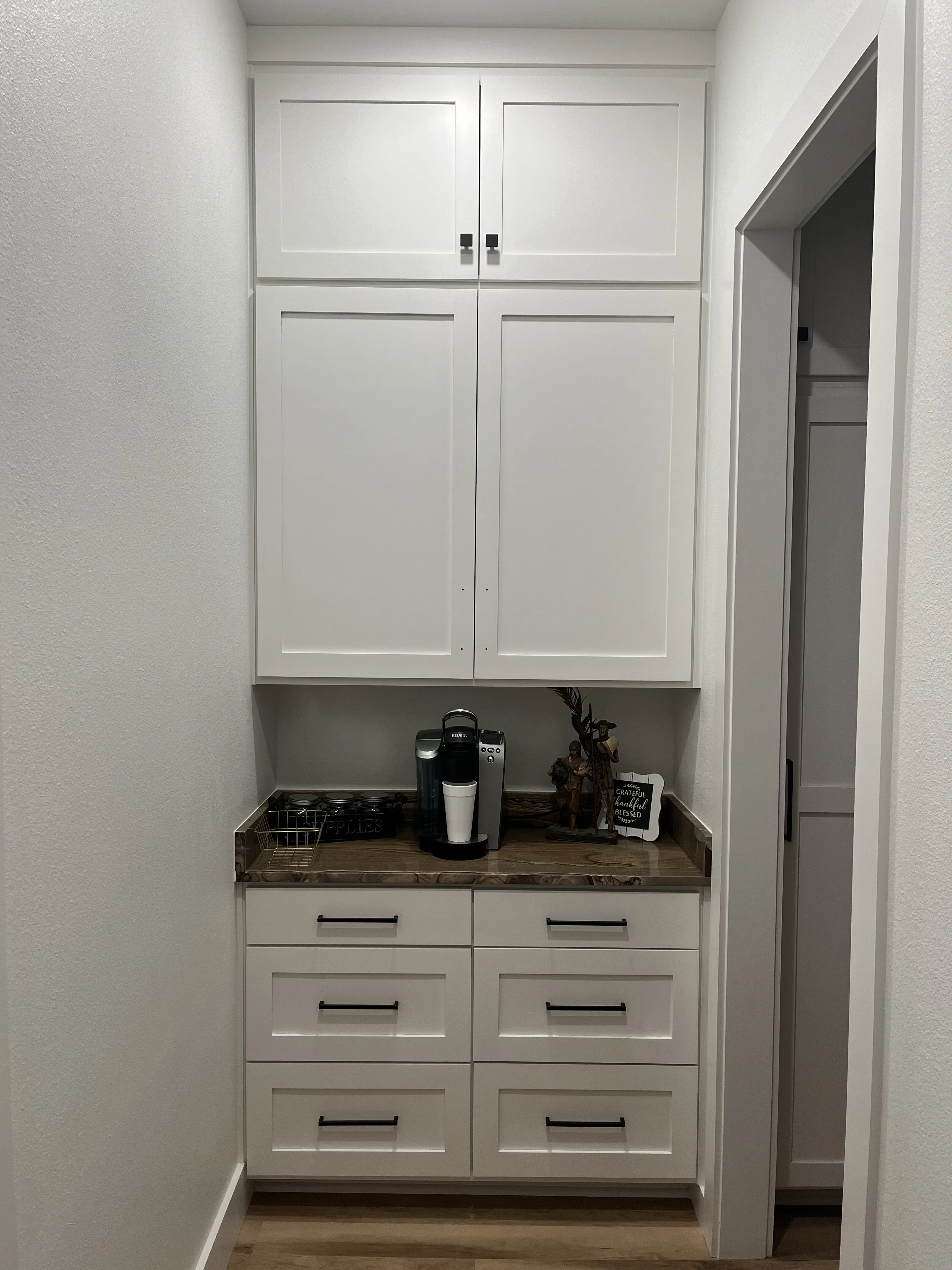 Butler's pantry coffee nook with white shaker cabinets and walnut counter