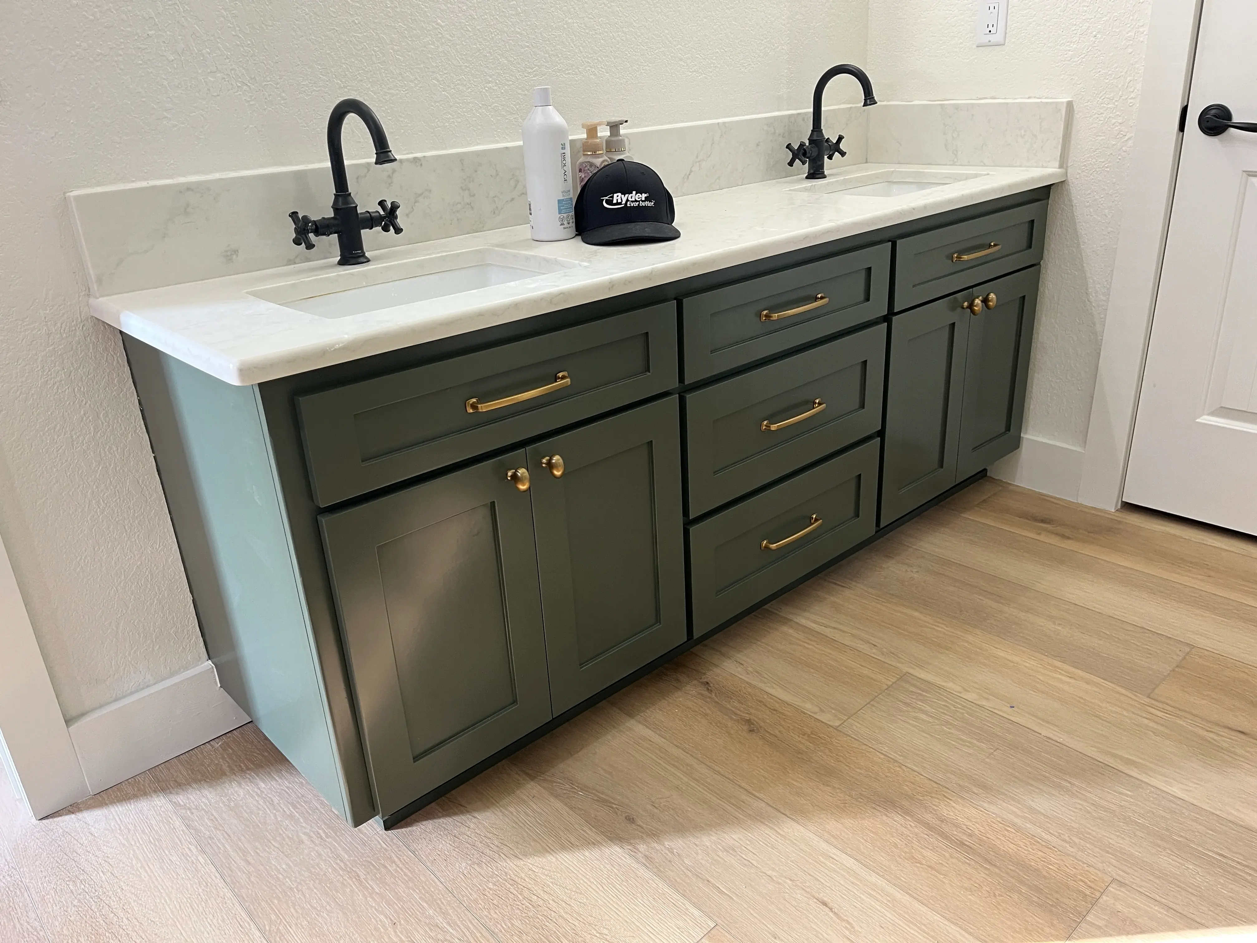 Olive green double vanity with brass hardware and marble countertop Greenwood AR